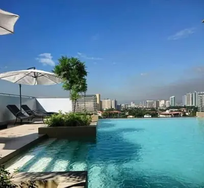 a swimming pool with a city skyline in the background at Sentinel Residences 1 bedroom partition in Manila