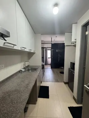 a kitchen with a sink and a counter top at Sentinel Residences 1 bedroom partition in Manila