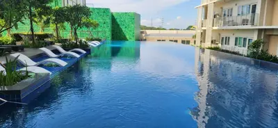a swimming pool in the middle of a building at 11a Spacious Suite with Resort Amenities Free Parking with Washer Great for Long Stays in Manila