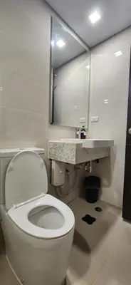 a bathroom with a white toilet and a sink at 11a Spacious Suite with Resort Amenities Free Parking with Washer Great for Long Stays in Manila