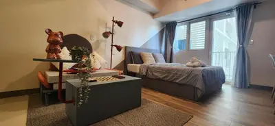 a small bedroom with a bed and a window at 11a Spacious Suite with Resort Amenities Free Parking with Washer Great for Long Stays in Manila