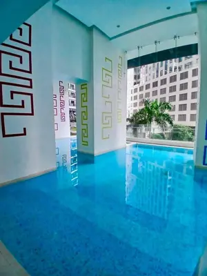 a swimming pool in a hotel room with a view of a building at 1BR in Makati Prime Location in Manila