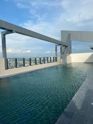 a swimming pool on the roof of a building with water at Casa Relajante at Recto Manila in Manila
