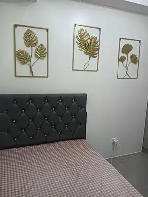 a bedroom with a bed and three pictures on the wall at Deca Cubao Tower Budget Condo by Ashti in Manila