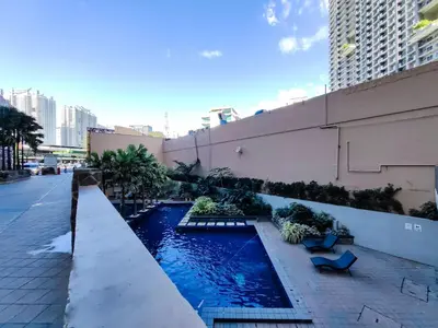 a swimming pool on the side of a building at 1BR Condotel Suite at Sunshine100 City Plaza #SS01-1 in Manila