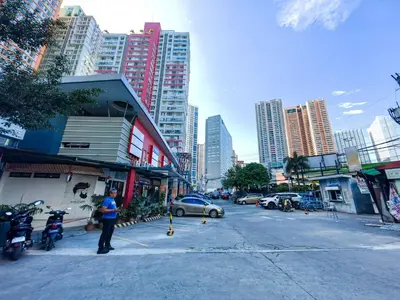 a person standing on a street in a city at 1BR Condotel Suite at Sunshine100 City Plaza #SS01-1 in Manila