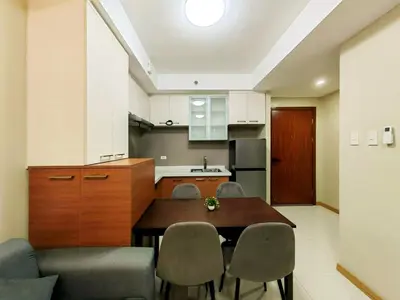 a kitchen and dining room with a table and chairs at 1BR Condotel Suite at Sunshine100 City Plaza #SS02-1 in Manila
