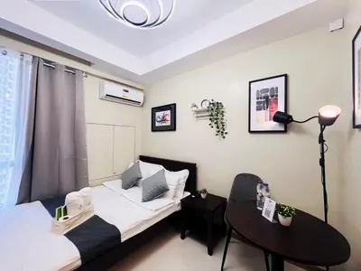 a small room with a bed and a table at 1BR Condotel Suite at Sunshine100 City Plaza #SS04-1 in Manila