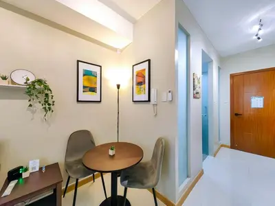 a room with a table and chairs and a hallway at 1BR Condotel Suite at Sunshine100 City Plaza #SS07-1 in Manila
