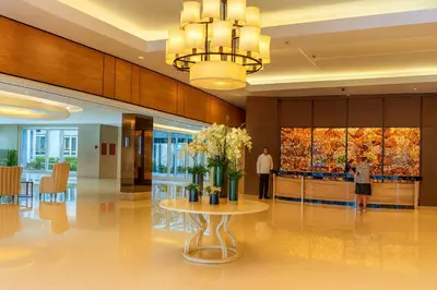 a lobby with a table with flowers on it at Very Spacious Condo at Mall of Asia in Manila