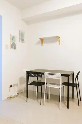 a black table and chairs in a white room at Very Spacious Condo at Mall of Asia in Manila