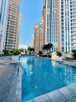 a large swimming pool in a city with tall buildings at Venice IG-Worthy , Netlfix Getaway walking distance to Mall in Manila