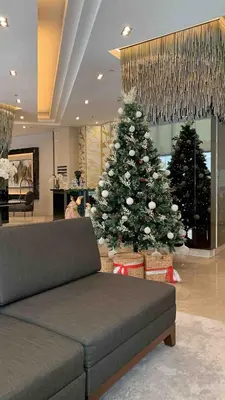 a christmas tree in a living room with a couch at Fame Tower 2 Luxury Queen with own Washer in Manila