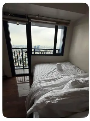 a bed in a room with a large window at Affordable Staycation Home in Makati in Manila