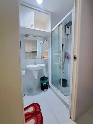 a bathroom with a shower and a sink at Sarah's Staycation at Sea Residences Near Moa in Manila