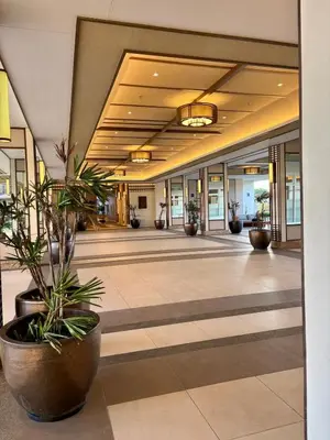 a lobby with potted plants in a building at Metro Zen at DMCI Satori Residence 1br in Manila