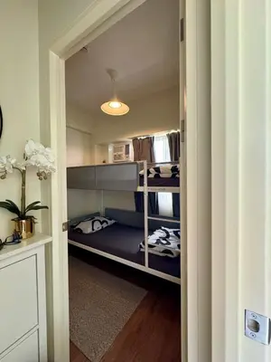 a hallway with bunk beds in a room at Metro Zen at DMCI Satori Residence 1br in Manila