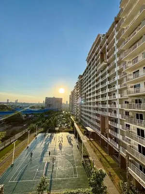 a tennis court in front of a large building at Metro Zen at DMCI Satori Residence 1br in Manila
