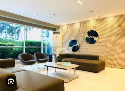 a living room with a couch and chairs and a table at Sea Residence Tower EF Lets in Manila