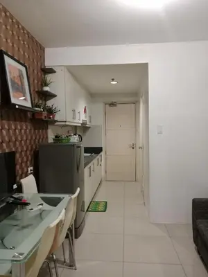 a kitchen with a table and a counter top at Sea Residence Tower EF Lets in Manila