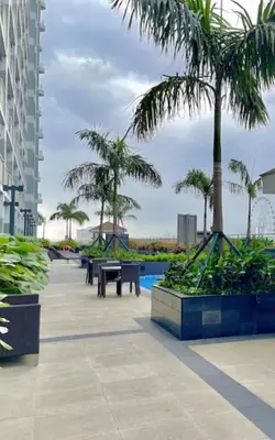 a resort with palm trees and a swimming pool at Coastresidences by Rinseiki in Manila
