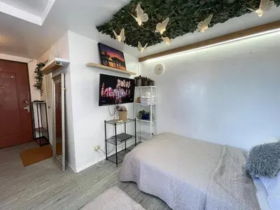 a bedroom with a bed and a ceiling with butterflies at Stylish unit in Ortigas near podium & holiday inn in Manila
