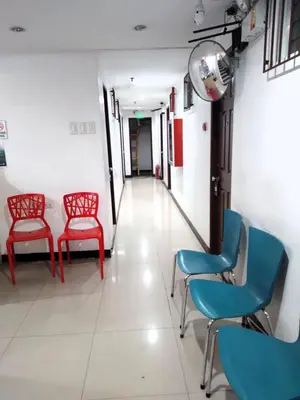 a waiting room with red and blue chairs at Harrison Suites in Manila