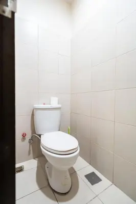 a bathroom with a white toilet in a room at One Uptown Residence BGC 2BR Cor unit with balcony ,washer in Manila