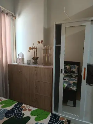 a bedroom with a mirror and a dresser and a bed at Shell Residences By Jhem Place in Manila