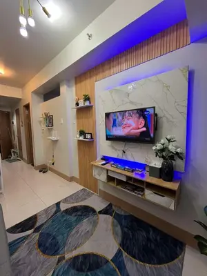 a living room with a flat screen tv on a wall at Shore3 Residences Tower2 Staycation in Manila