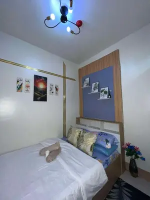 a bedroom with a bed with a stuffed animal on it at Shore3 Residences Tower2 Staycation in Manila