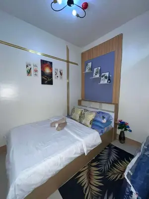 a bedroom with a large bed with a white bedspread at Shore3 Residences Tower2 Staycation in Manila