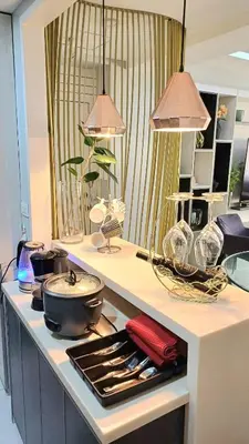 a kitchen counter with a stove with pots and pans at 2 BR, 2 Full Bathrooms, with hotel feels and a jet tub in Manila