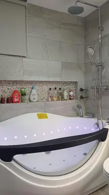 a white bath tub in a bathroom with a counter at 2 BR, 2 Full Bathrooms, with hotel feels and a jet tub in Manila