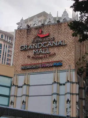 a sign for a grand central mall on the side of a building at Condo Suite 1 Bedroom McKinley West Taguig City in Manila