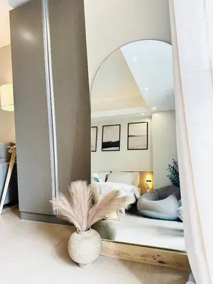 a bedroom with a bed with a large mirror at Exquisite Japandi 2 & Mediterranean Breeze at Venice w Grand Canal View! in Manila
