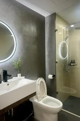a bathroom with a toilet and a sink and a shower at Exquisite Japandi 2 & Mediterranean Breeze at Venice w Grand Canal View! in Manila