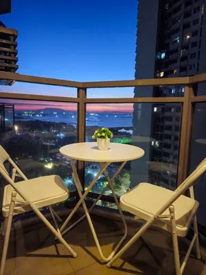 a table and chairs on a balcony with a view at Galini Suites in Manila