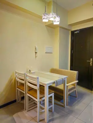 a dining room with a table and chairs at Galini Suites in Manila