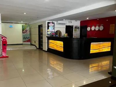 a restaurant with a counter with clocks on the wall at Hotel Sogo EDSA Shaw Blvd in Manila