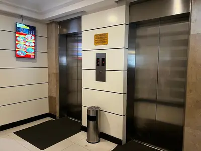 a elevator in a building with a trash can at Hotel Sogo EDSA Shaw Blvd in Manila