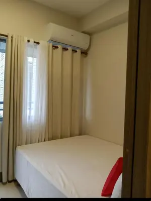 a small bedroom with a bed and a air conditioner at One Bedroom Unit in Fame Residences in Manila