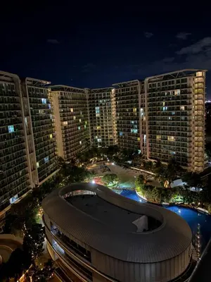 a view of a large building at night at Sunset and Breeze by Azure in Manila