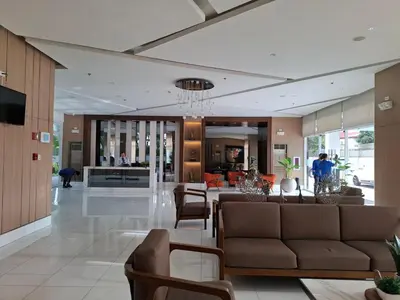a living room with a couch and a dining room at QUINS STAYCATION One Bedroom at SMDC South Residences in Manila