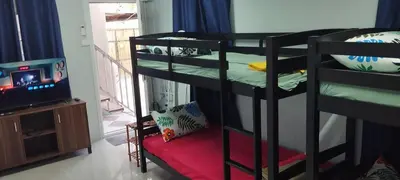 a room with two bunk beds and a television at 6 Guest - Unit 4 Studio Type - Container house in Santa Rosa