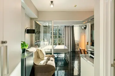 a living room with a couch and a chair at Casa Attila - Azure Urban Resort Residences in Manila