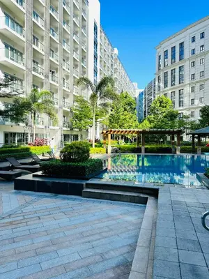 a courtyard with a swimming pool in a building at 81 Newport Blvd Cluster 5 unit 5K by Rechelle Nunag in Manila