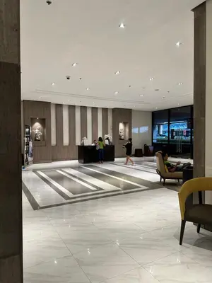 a lobby with people walking around in a building at 81 Newport Blvd Cluster 5 unit 5K by Rechelle Nunag in Manila