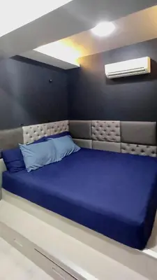 a bed in a room with a blue mattress at 1 Master BR with full bathroom and JET TUB plus 2nd BR with full bathroom Elegant fully furnished with hotel feels in Manila
