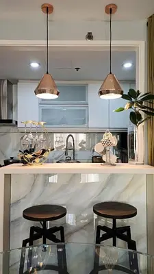 a kitchen with two tables and two stools at 1 Master BR with full bathroom and JET TUB plus 2nd BR with full bathroom Elegant fully furnished with hotel feels in Manila